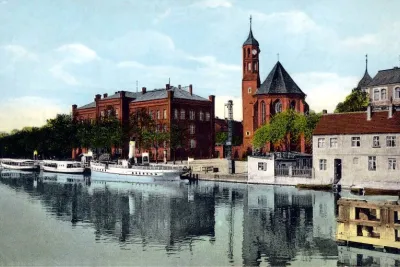 Vintage tinted postcard of Brandenburg an der Havel with a brick church tower and riverboats