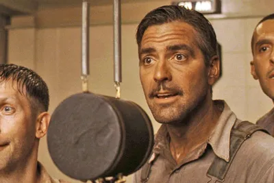 Still from O Brother, Where Art Thou?: three convicts singing into a vintage radio microphone