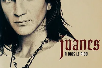 Cover of A Dios le Pido by Juanes, a sepia close-up of the long-haired singer