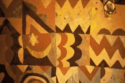 Earth-toned painted African pattern of zigzags, circles, a star and a crescent