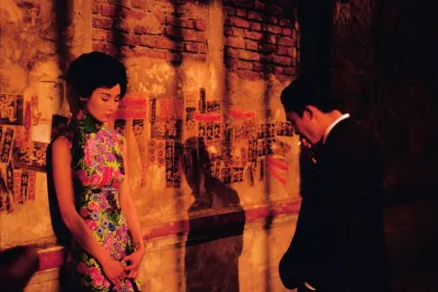 Still from In the Mood for Love: woman in floral qipao and man in suit