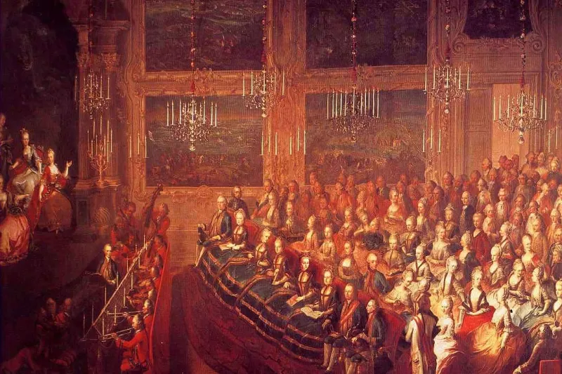 18th-century painting of a court concert in a chandelier-lit hall packed with listeners