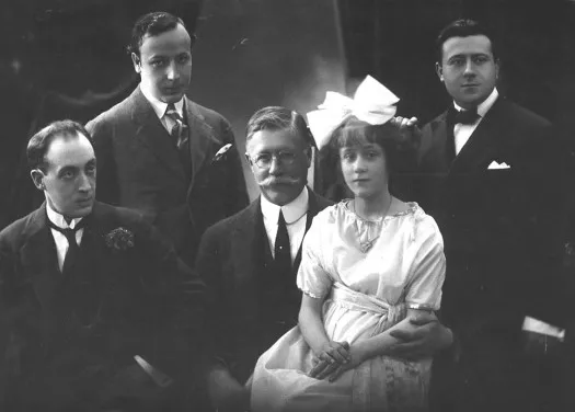 Group portrait of young María Luisa Anido with her father and guitarists Llobet, Pujol and Prat