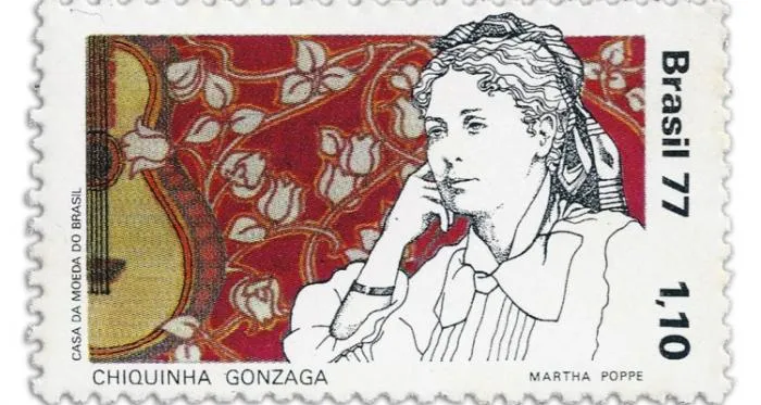 Brazilian 1977 postage stamp with a drawing of Chiquinha Gonzaga beside a guitar