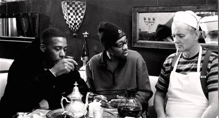 Still from Coffee and Cigarettes: GZA and RZA at a table with an aproned Bill Murray