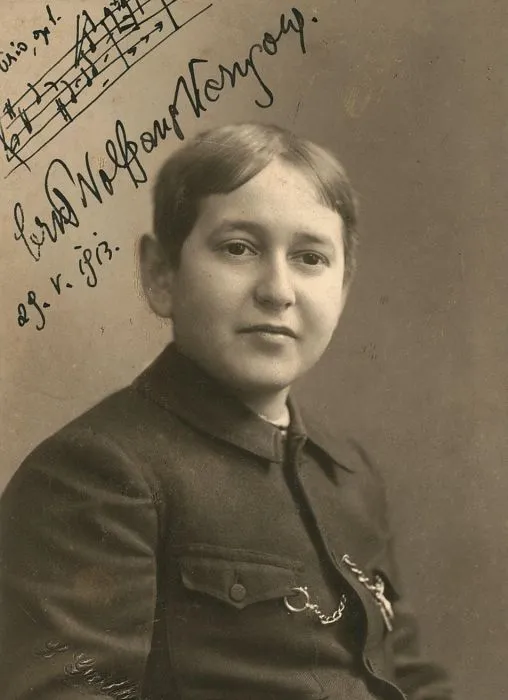 Signed sepia portrait of a young Erich Wolfgang Korngold, dated 1913, with a musical quotation