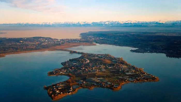 Aerial view of Reichenau Island in Lake Constance with the snowy Alps on the horizon