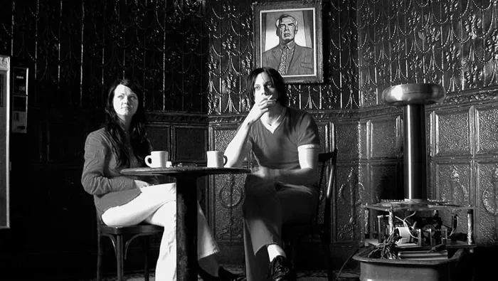 Still from Coffee and Cigarettes: Jack and Meg White at a café beside a Tesla coil