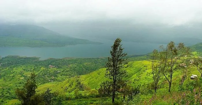 Green monsoon hills and a lake under low clouds, seen from Sydney Point in Panchgani